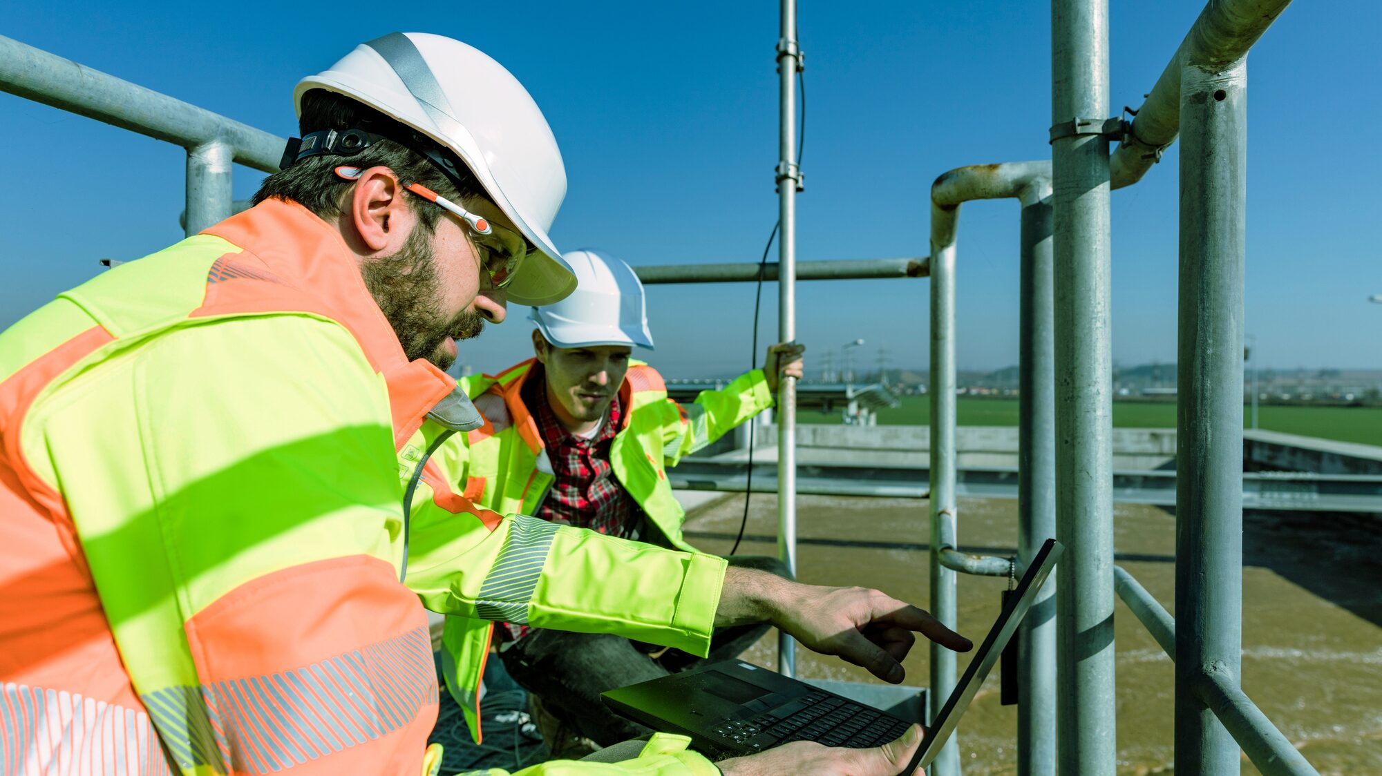 Technician in high-visibility clothing working on plant equipment
